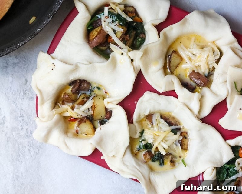 muffin tin filled with mini quiches ready to be baked.