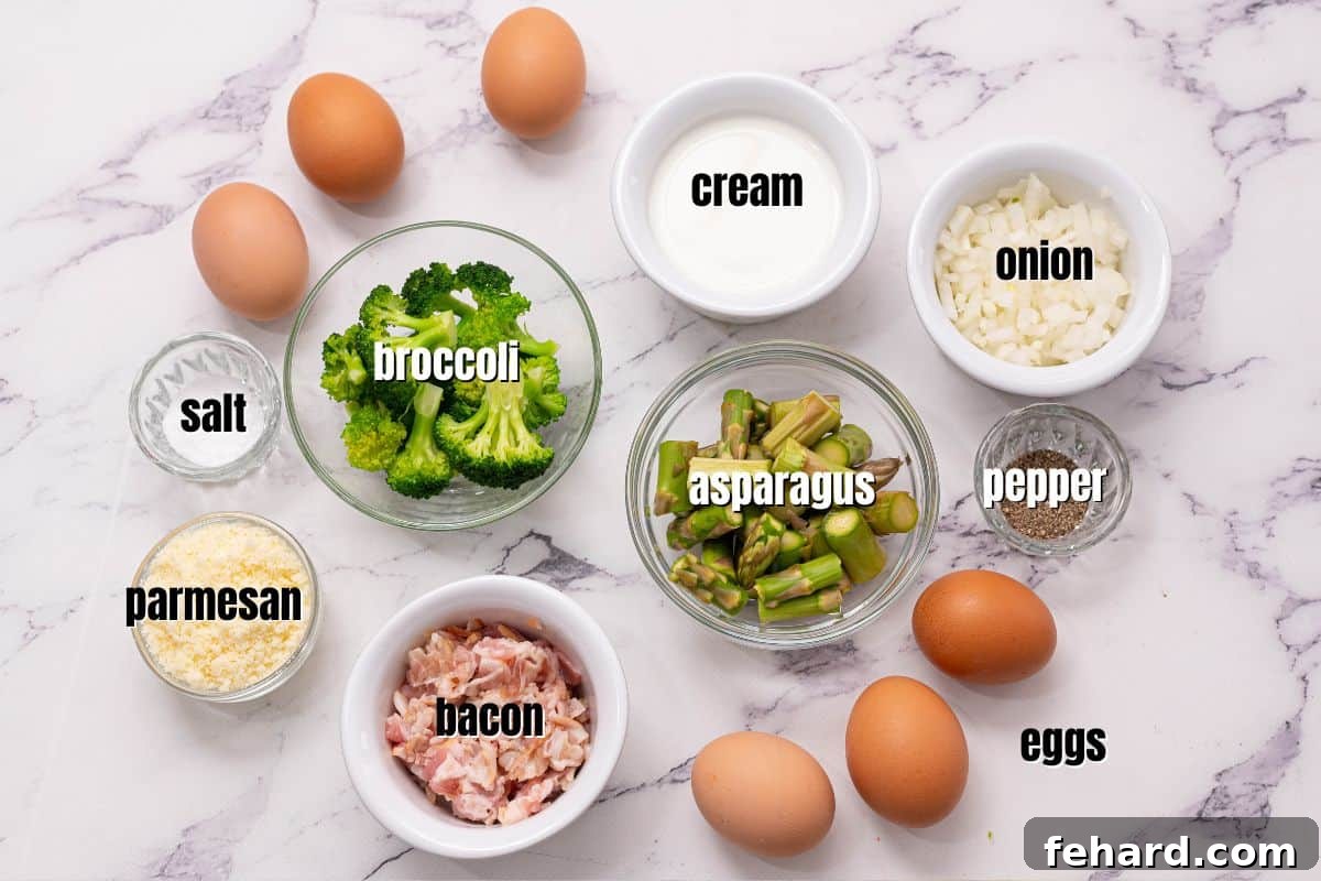 A flat lay of fresh ingredients laid out on a wooden cutting board, including bundles of green asparagus, vibrant broccoli florets, sliced yellow onion, strips of uncooked bacon, and a bowl of whisked eggs with cheese.