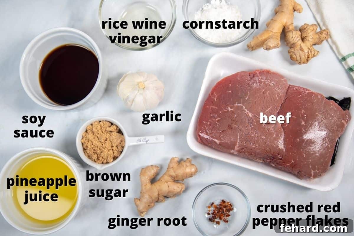 Ingredients for Mongolian Beef laid out on a kitchen counter, including beef, pineapple juice, soy sauce, ginger, garlic, and red pepper flakes.