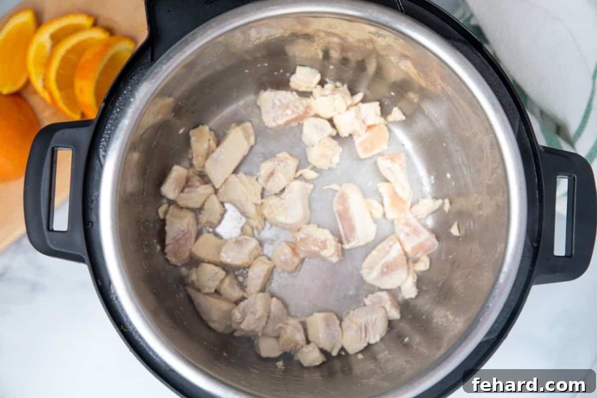 Sauteed chicken inside inner pot of instant pot. 