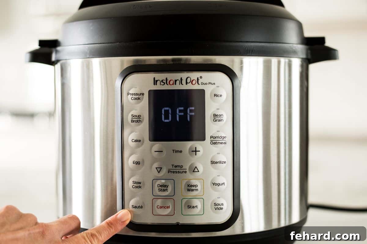 Instant Pot Sauté Buttons Explained Finger pointing to the Sauté button on an Instant Pot control panel.