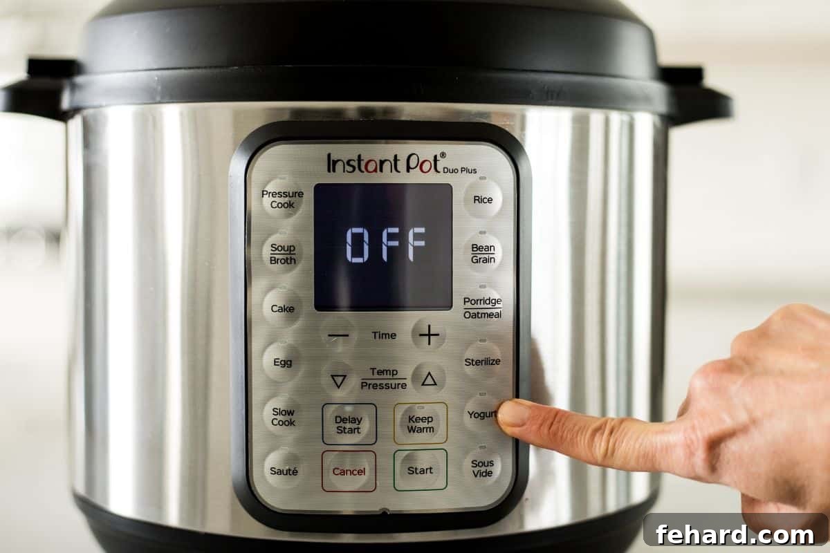 Demystifying Instant Pot Settings: The Yogurt Function Finger pointing to the Yogurt button on an Instant Pot control panel.