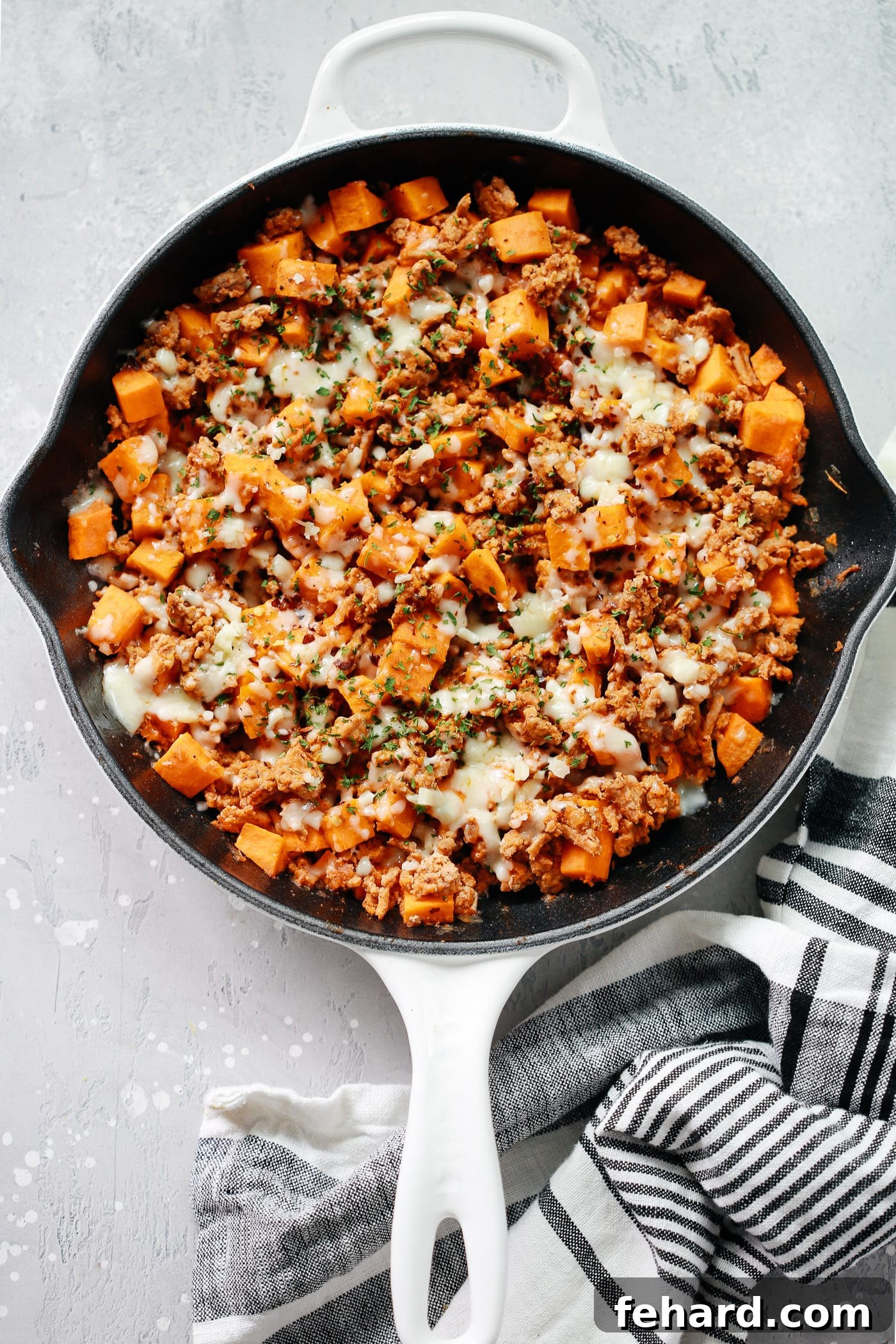 Turkey & Sweet Potato Hash 2 A beautifully cooked Ground Turkey Sweet Potato Skillet, garnished with fresh herbs, ready to be served as a delicious gluten-free meal.