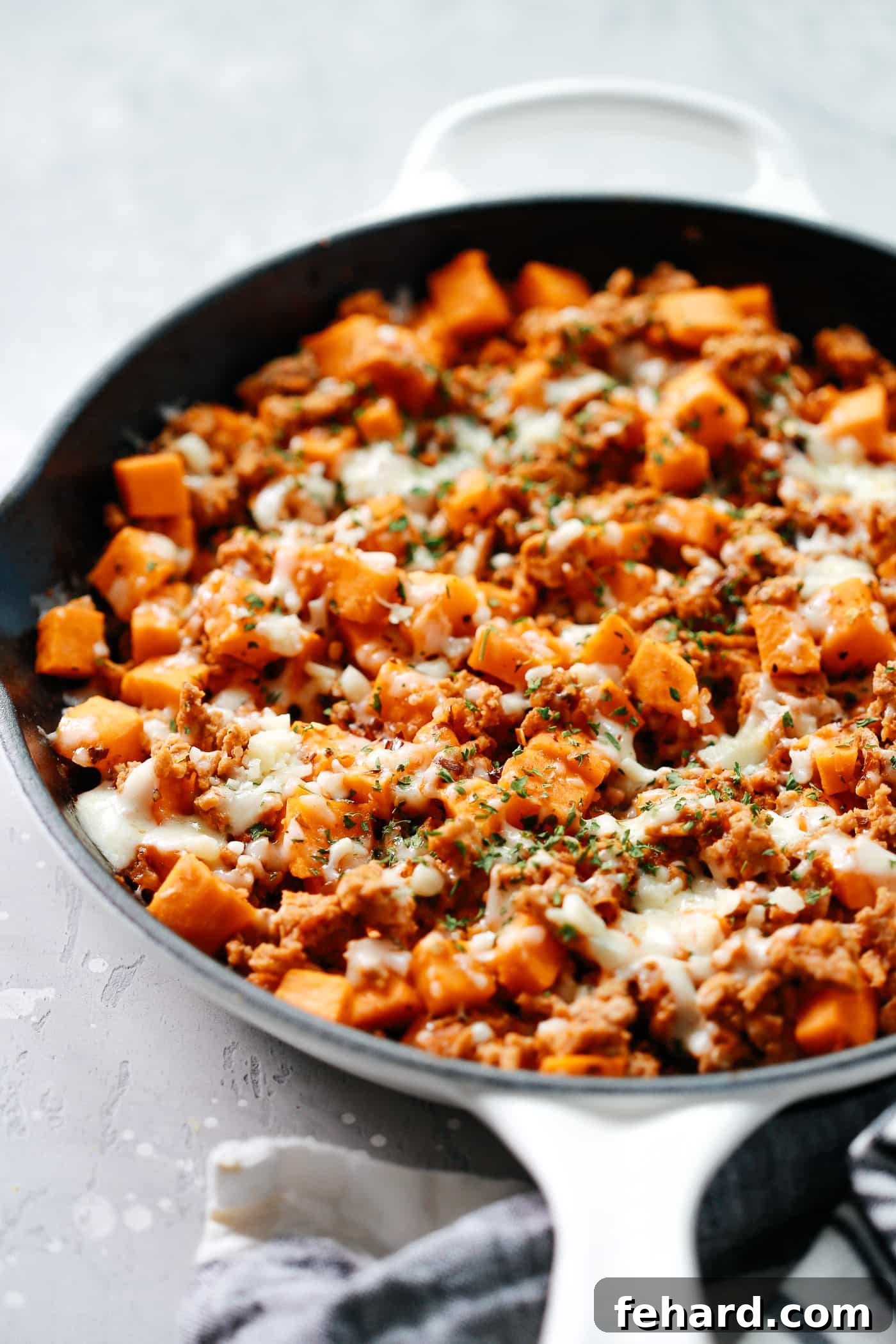Turkey & Sweet Potato Hash 3 Close-up shot of the savory Ground Turkey Sweet Potato Skillet, highlighting the tender turkey, vibrant sweet potatoes, and melted cheese topping.