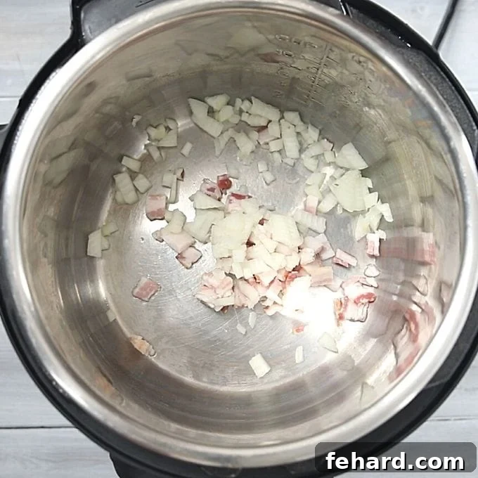 Instant Pot Baked Beans Recipe Step Chopped bacon and minced onion sautéing in the Instant Pot.