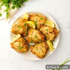 A serving plate showcasing delicious Instant Pot chicken thighs, garnished with fresh parsley.