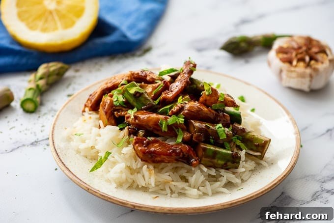 Instant Pot Stir Fry is Not Efficient A vibrant Honey Lemon Chicken Stir Fry served over white rice in a bowl.