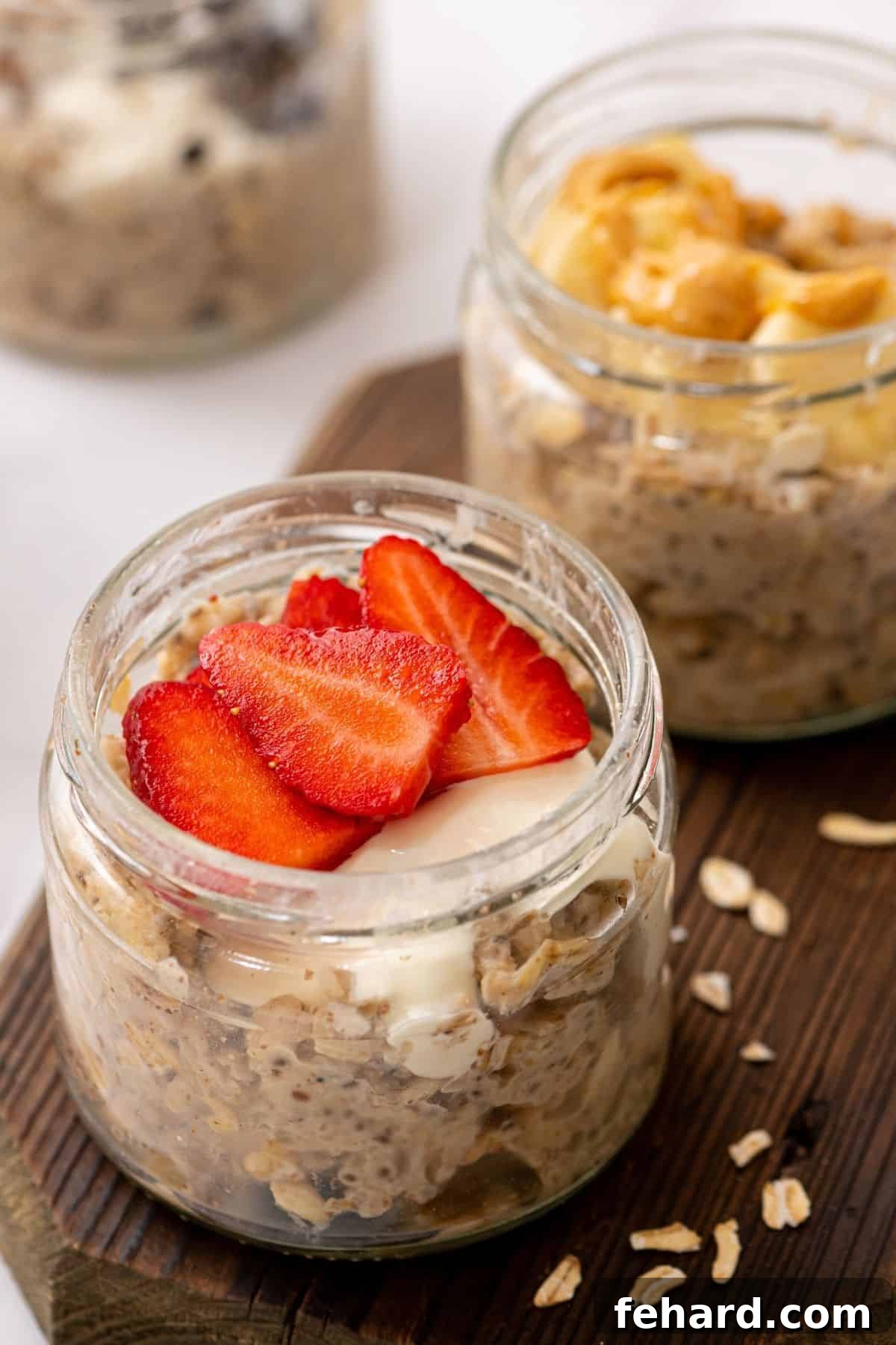 Two jars of overnight oatmeal topped with fresh fruit.