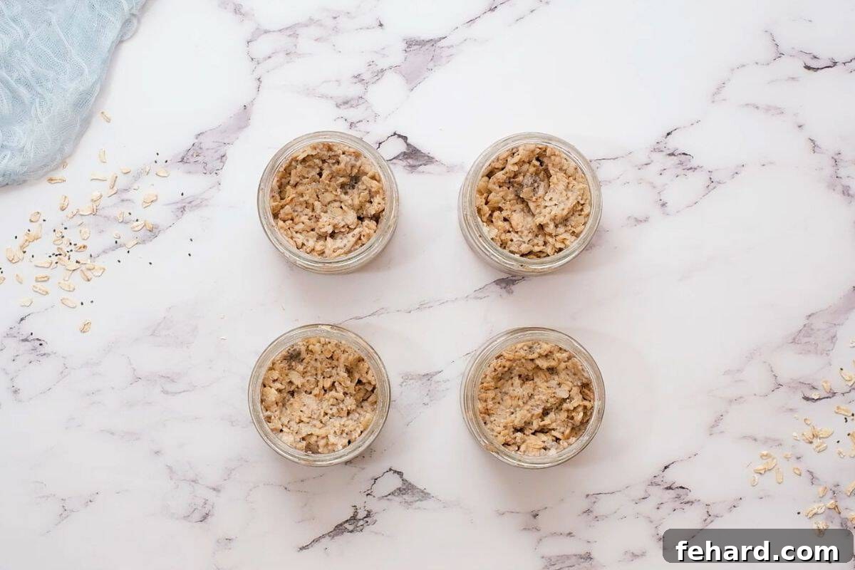 Four jars of overnight oats after refrigeration and oats have thickened up.