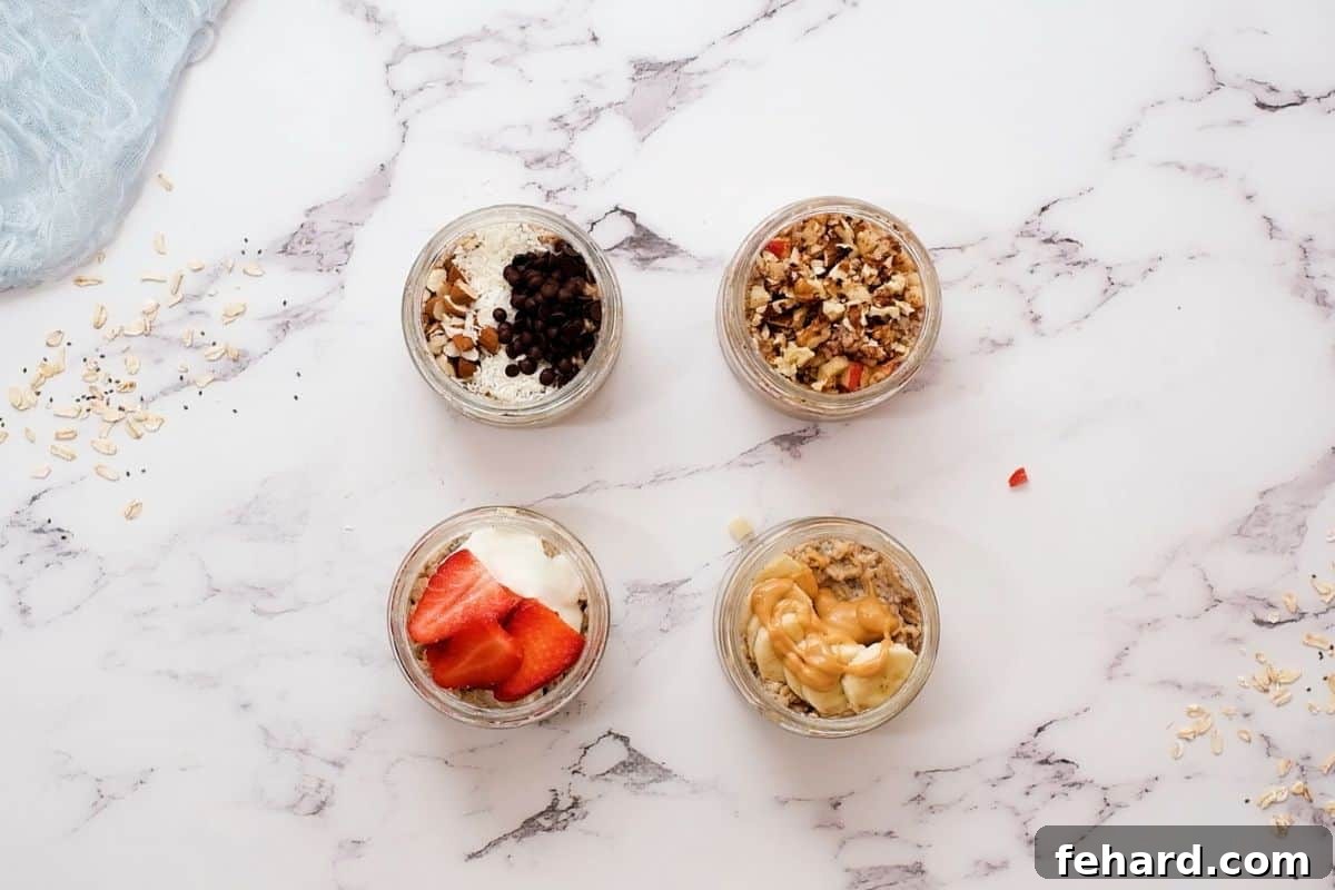 Four jars of prepared overnight oats topped in four different ways; one with banana, one with strawberries, one with nuts, and one with chocolate.