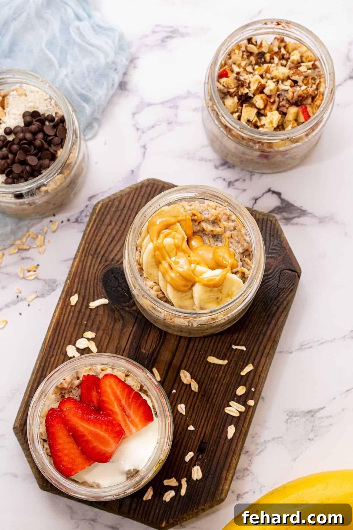 Jars of overnight oatmeal topped with fresh fruit and almond butter.