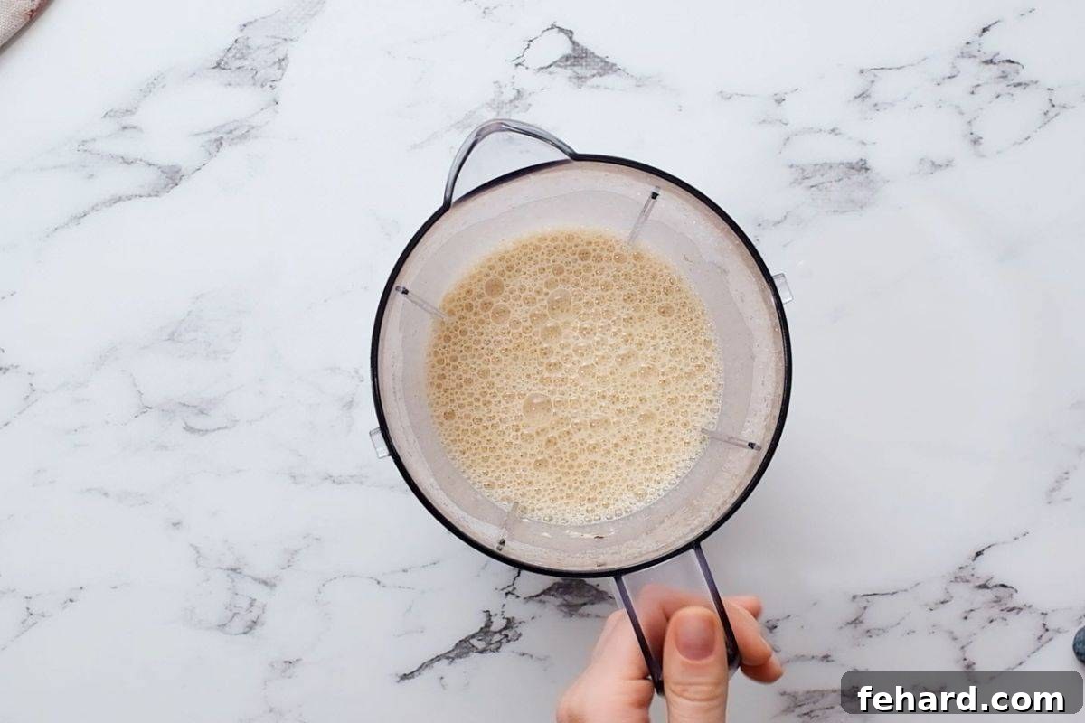 Smooth, well-blended Dutch Baby Pancake batter swirling in a blender, ready for baking.