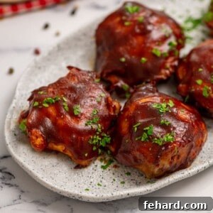 Close up of BBQ Chicken Thighs on white platter.