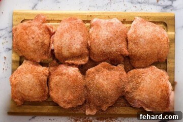 Seasoned Chicken Thighs on cutting board.