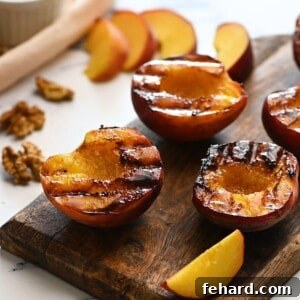 Grilled Peach Perfection 3 Grilled Cinnamon Sugar peaches on wooden cutting board.