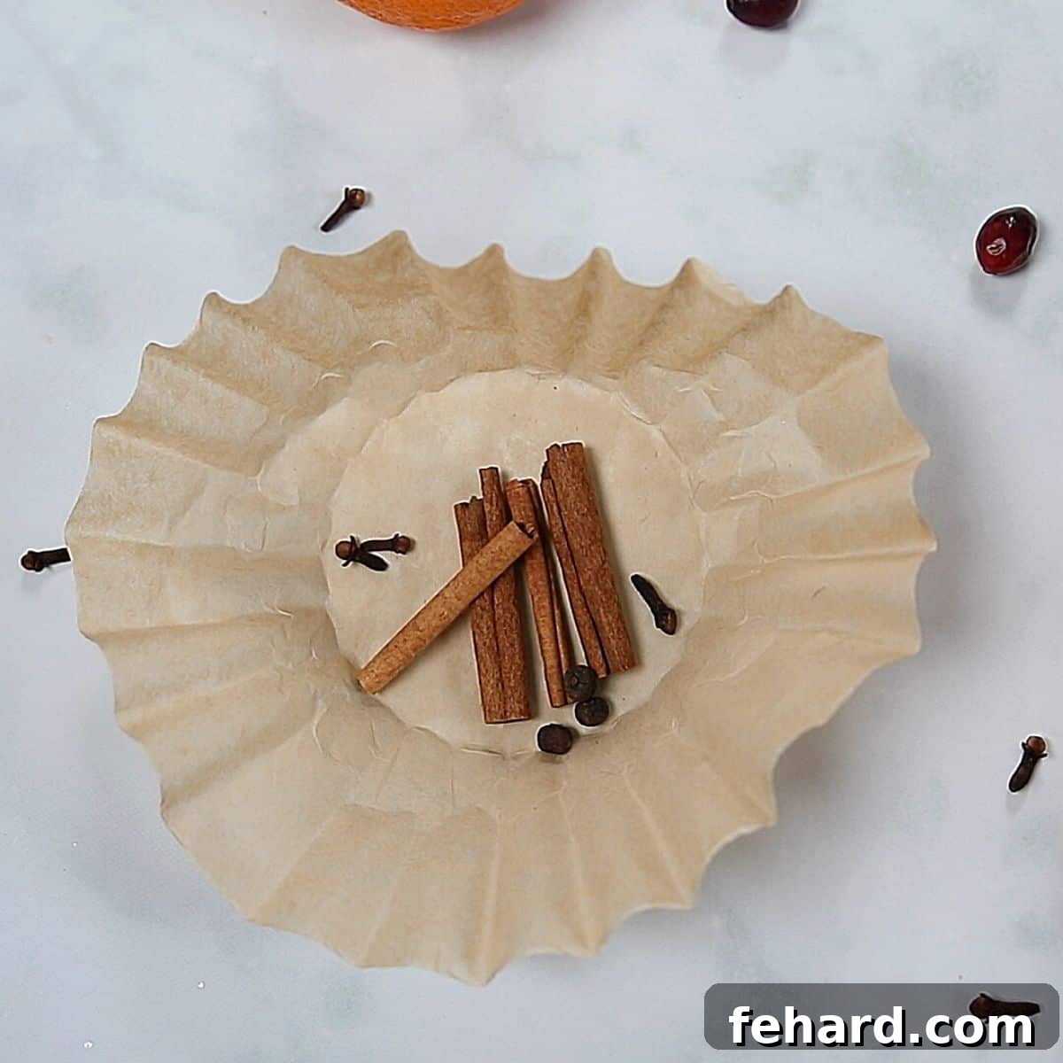 Preparing Mulled Wine Spices Whole spices neatly bundled in a coffee filter
