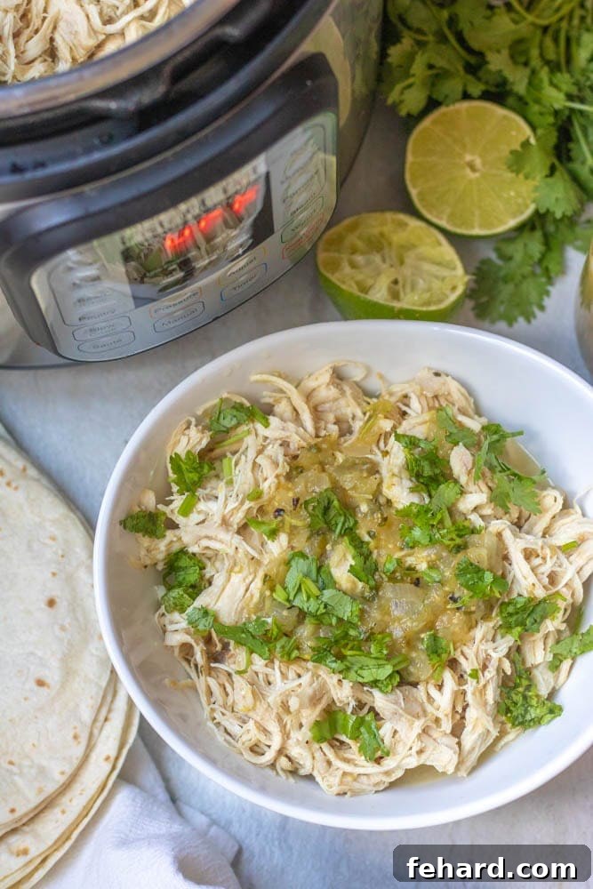 Instant Pot Salsa Verde Chicken Shredded Salsa Verde Chicken Breast next to instant pot, garnished with fresh cilantro.