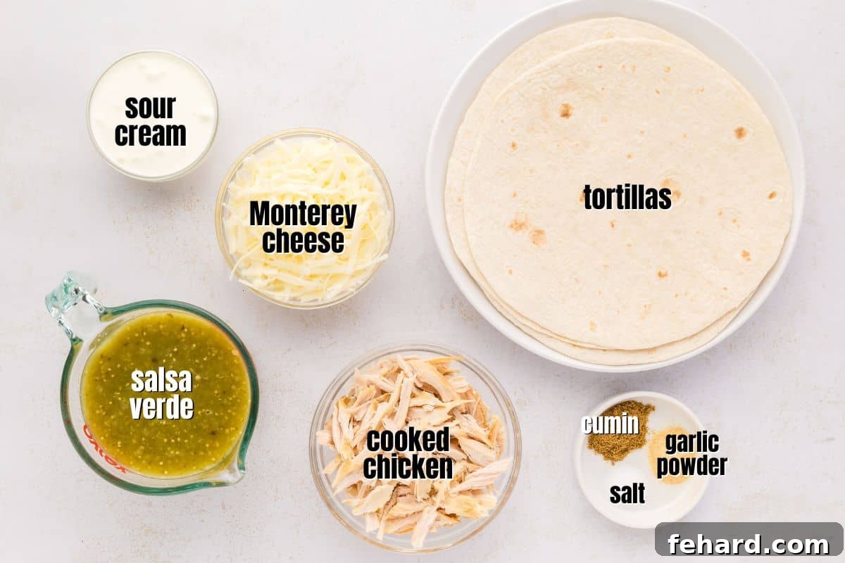 Labeled ingredients for homemade salsa verde chicken enchiladas, meticulously laid out on a clean kitchen counter, including fresh chicken, soft tortillas, creamy sour cream, vibrant salsa verde, and shredded cheese.
