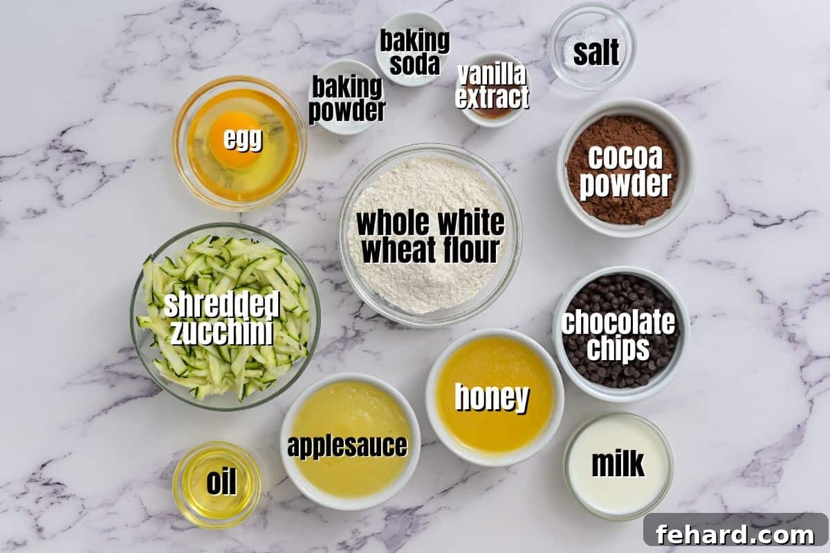 Ingredients for zucchini muffins labeled on counter.