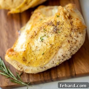 Baked Chicken Breast on Wooden Cutting board.