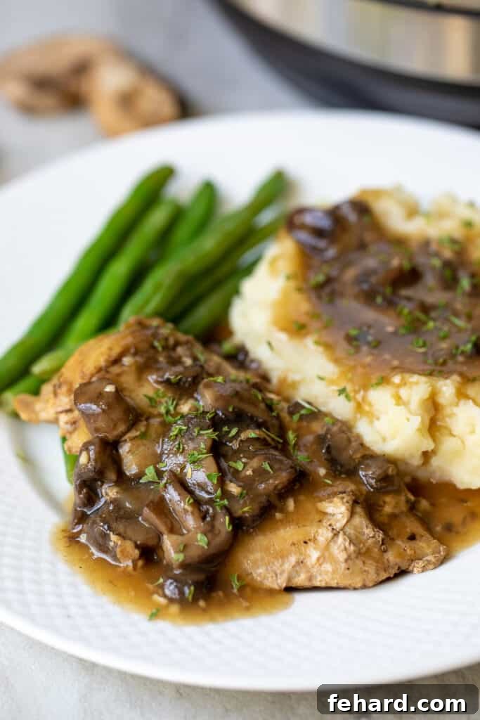 Instant Pot Chicken Marsala on white plate with mashed potatoes and green beans