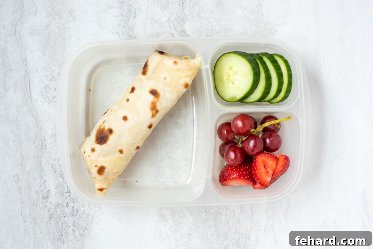 Easy Peanut-Free Recipes: Freezer Bean Burrito Bean Burrito with strawberries, grapes, and cucumbers, illustrating a balanced and easy nut-free lunch.