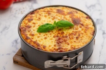 Lasagna in springform pan after being broiled in oven.