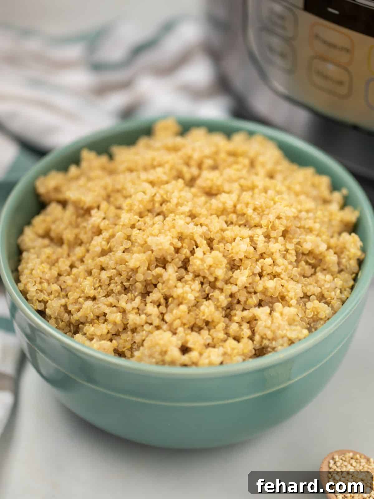 Instant Pot Quinoa Recipe A bowl of perfectly cooked, fluffy quinoa sits invitingly in front of an Instant Pot, ready to be served as a healthy meal.