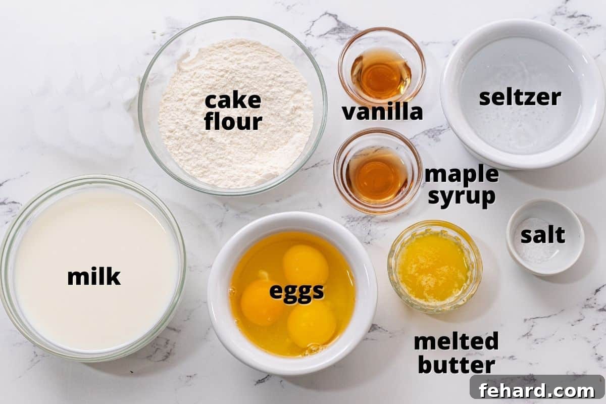 A collection of fresh ingredients for crepes, including eggs, milk, flour, and butter, neatly arranged on a rustic wooden surface.