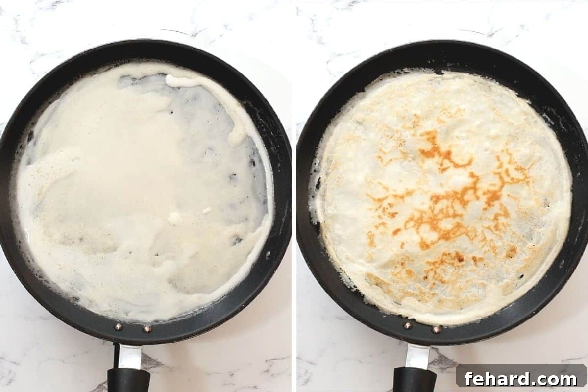 A crepe cooking in a skillet, showing both the uncooked batter on one side and the perfectly golden, cooked side after flipping.