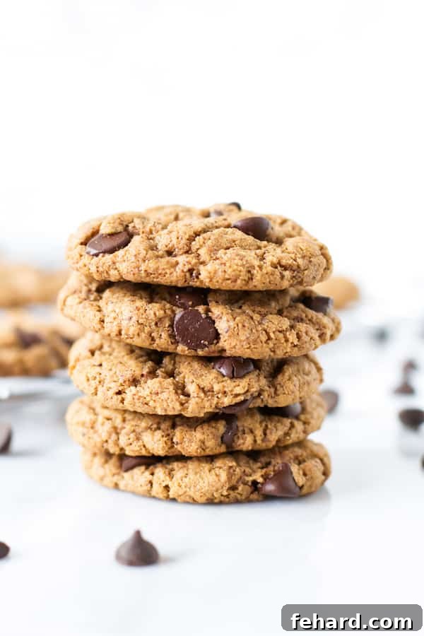A stack of five perfectly baked gluten-free chocolate chip cookies.