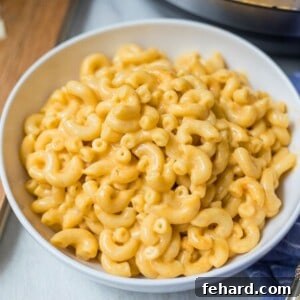 Bowl of Instant Pot Mac and Cheese Next to Instant Pot.