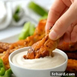 Instant Pot Chicken Wing being dipped into ranch dressing.