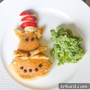 Cat in the hat pancake with green eggs on white plate