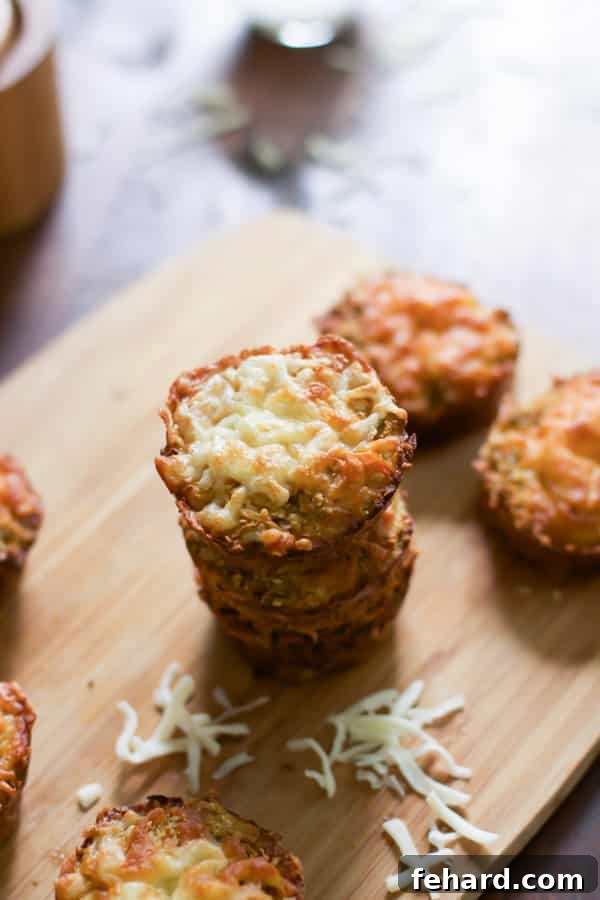 A stack of golden-brown cauliflower muffins on a rustic cutting board, ready to be enjoyed.