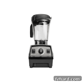 A powerful black Vitamix blender, essential for making smoothies, soups, and sauces with exceptional smoothness.