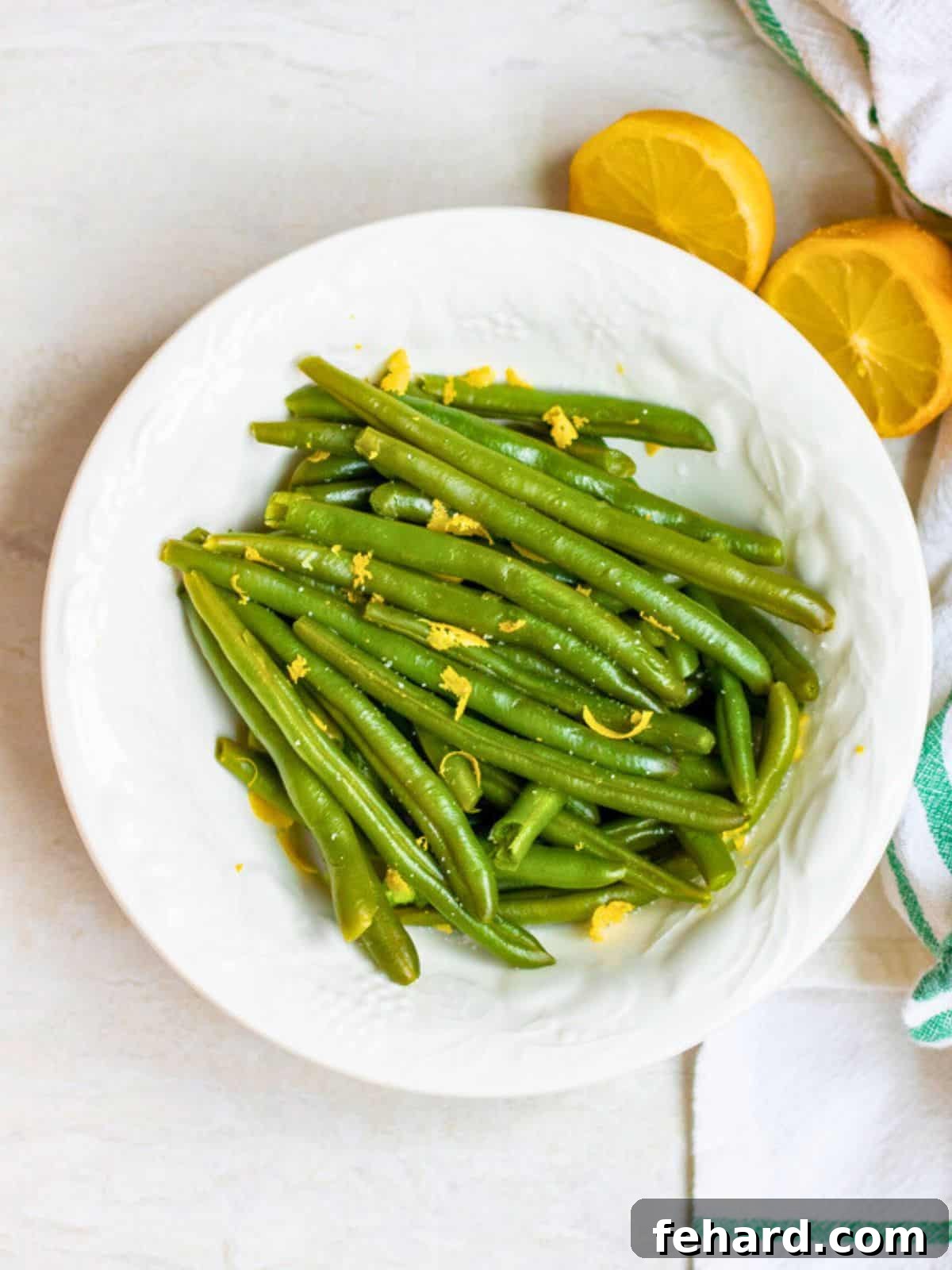 Pressure Cooker Steamed Green Beans Bowl of Instant Pot Green Beans topped with fresh lemon zest and kosher salt, highlighting their crisp-tender texture.
