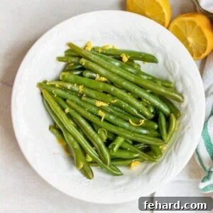 Perfect Instant Pot Green Beans 4 Bowl of perfectly steamed Instant Pot green beans with lemon zest and lemon juice, ready to serve.