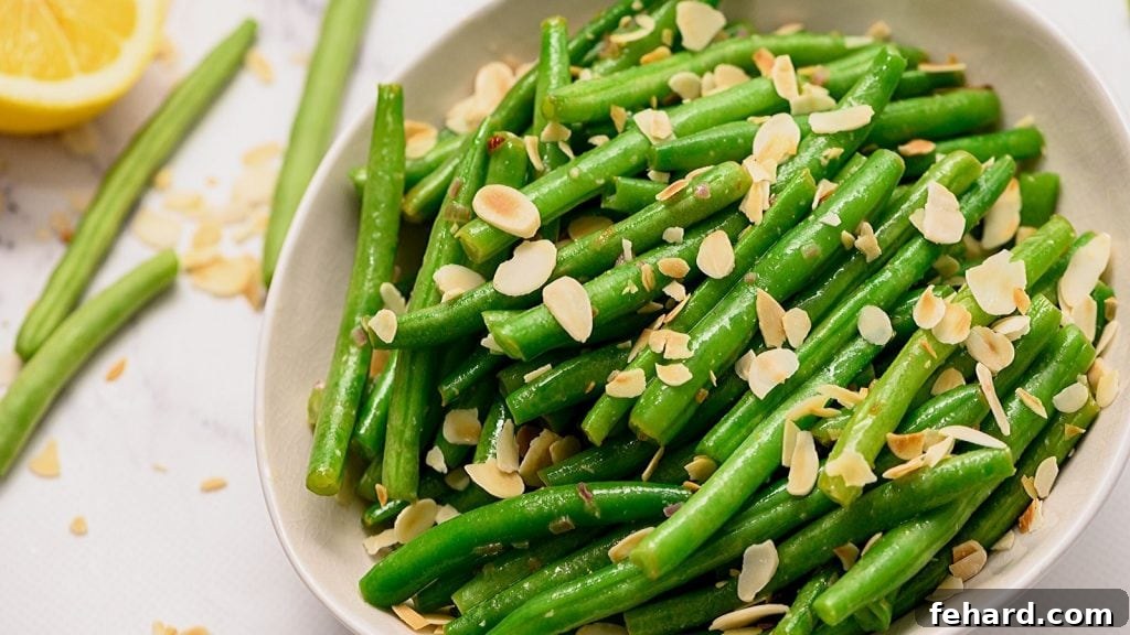 Green Beans Almondine arranged artfully in a white serving platter, ready to be enjoyed.