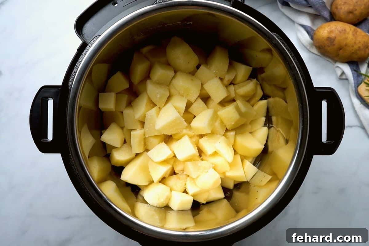 Cubed potatoes inside inner pot of Instant Pot for making mashed potatoes.