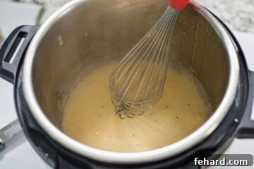 Whisk inside inner pot whisking turkey gravy.