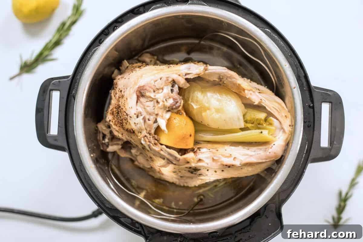 Cooked turkey breast on a trivet inside an Instant Pot after pressure cooking.