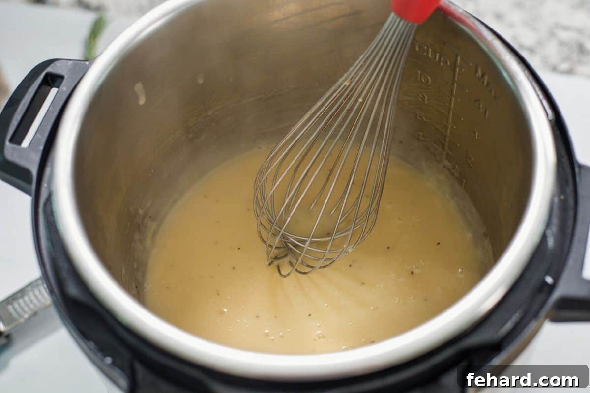 Whisk stirring turkey gravy in the inner pot of an Instant Pot.