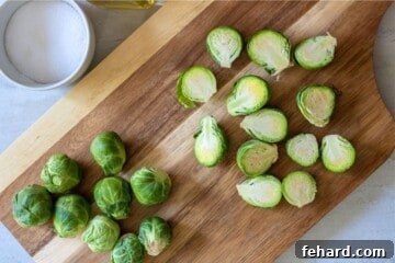 Prepared Brussel Sprouts on wooden cutting board.