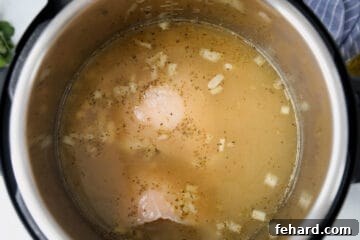 Ultimate Instant Pot White Chicken Chili 5 Ingredients for white chicken chili inside inner pot.