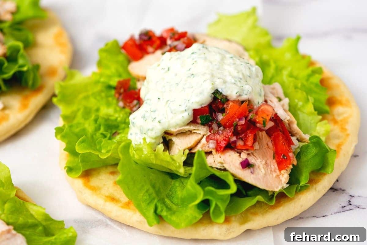 Pita topped with grilled greek chicken, lettuce, tomatoes, and Tzatziki sauce.