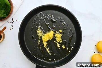 Garlic lightly toasted in extra virgin olive oil in large saute pan.