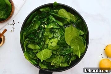 Fresh spinach tossed with garlic and lemon in large saute pan.