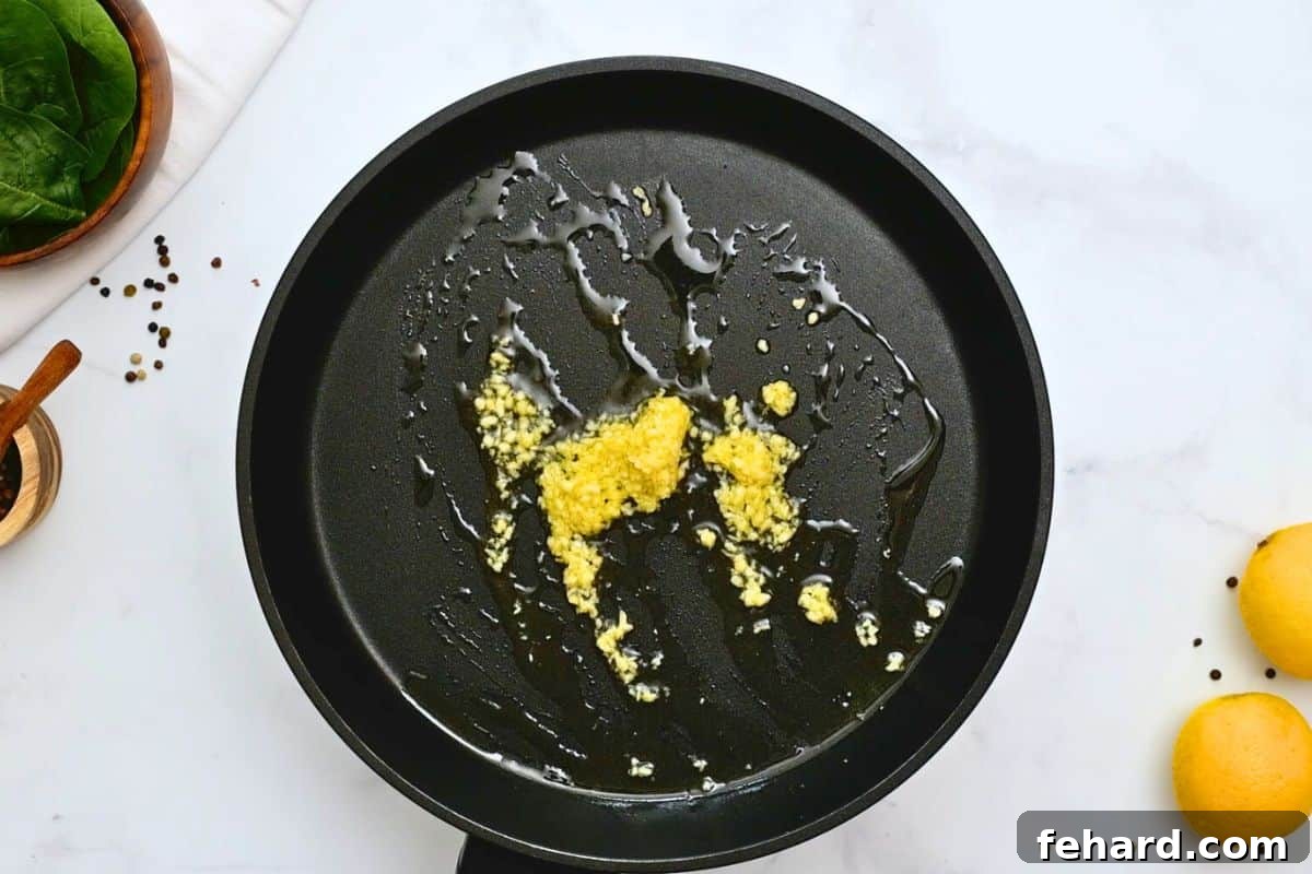 Garlic lightly toasted in extra virgin olive oil in large saute pan.
