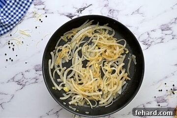 Caramelized onion in skillet, golden and soft.